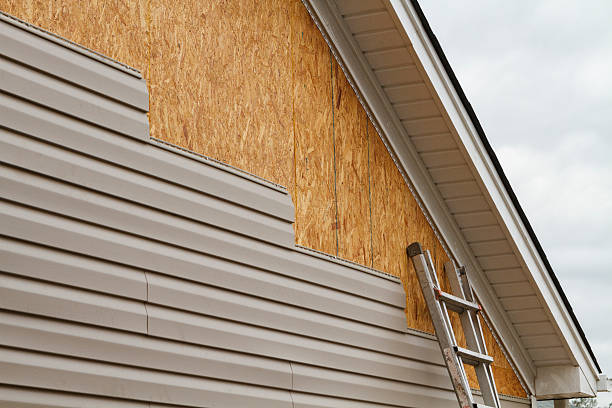 Professional Storm Damage Siding Repair technician working in Canfield, OH